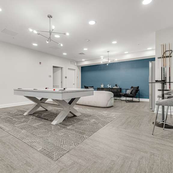 A room with a pool table and chairs. at Park Lamont Apartments & Townhomes, Ohio