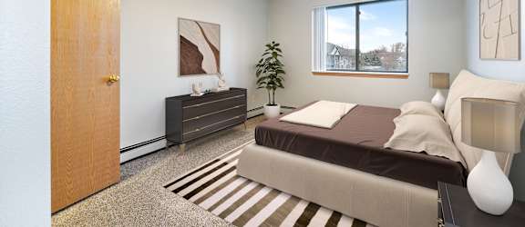 A bedroom with a bed, nightstand, and a ceiling fan.
