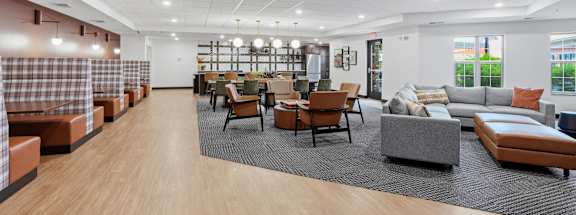 A spacious waiting area with wooden floors and modern furniture.