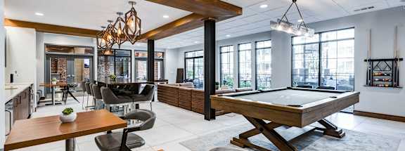 a game room with a pool table and a bar