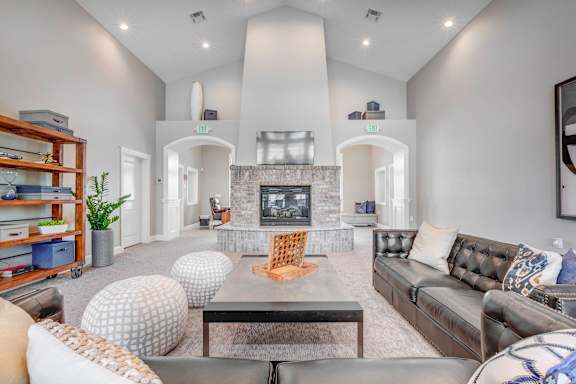 A modern living room with a fireplace and a large couch.