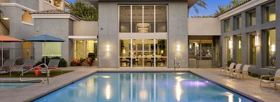 A modern house with a pool in the backyard.