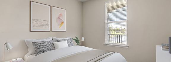 A bedroom with a large bed and a window with blinds.