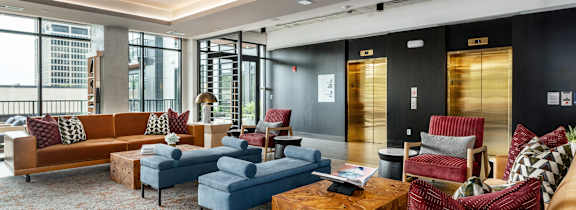 a living room filled with furniture and a large window