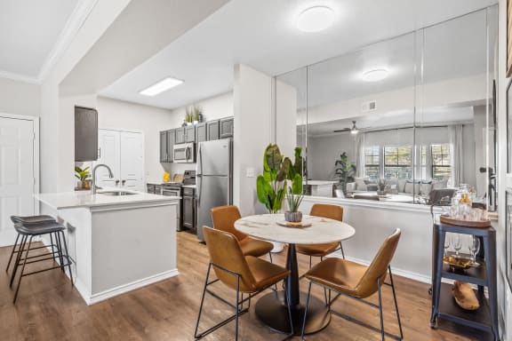 an open kitchen and dining area with a table and chairs