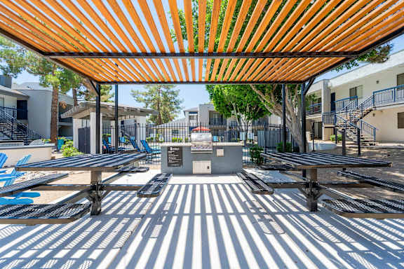 A playground with a striped floor and a striped canopy.