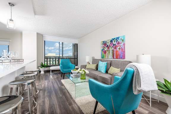 a living room with blue chairs and a couch