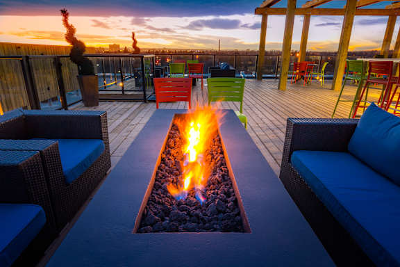A fire pit is the centerpiece of a patio with seating.
