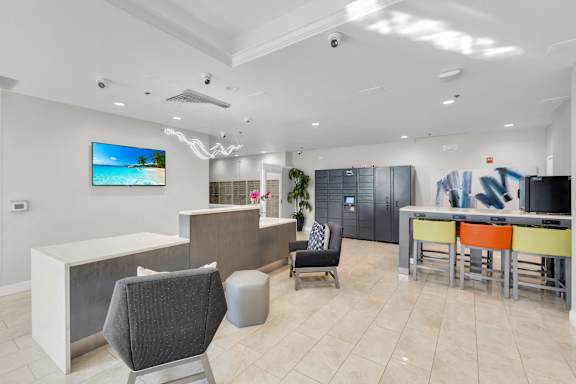 a lobby with a bar and chairs and a table with chairs