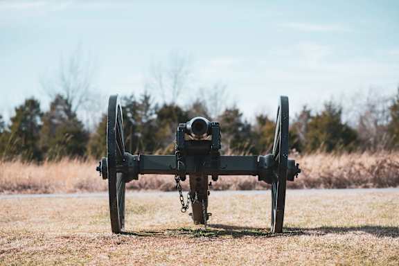 A cannon is on display in a field.