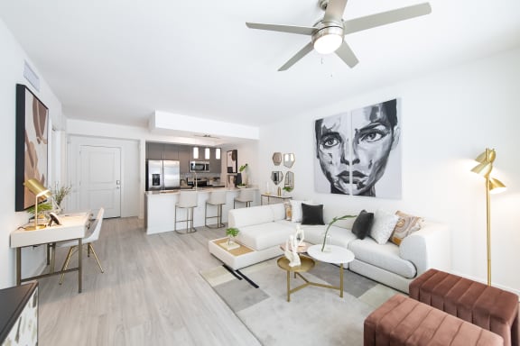 a living room with white walls and hardwood floors