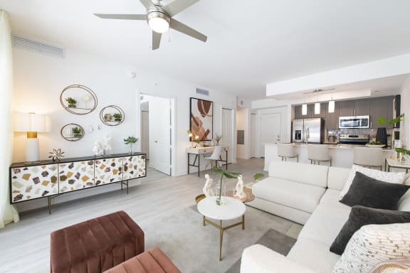 a living room with white couches and a white coffee table