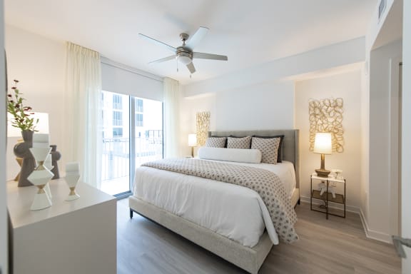 a bedroom with a bed and a ceiling fan