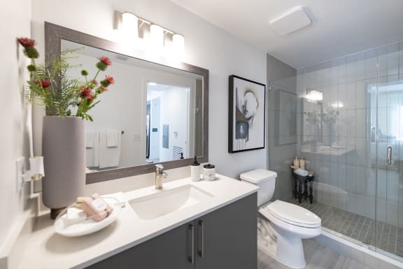 a bathroom with a toilet sink and shower