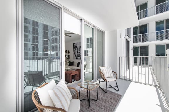 a living room with a white couch and a glass coffee table