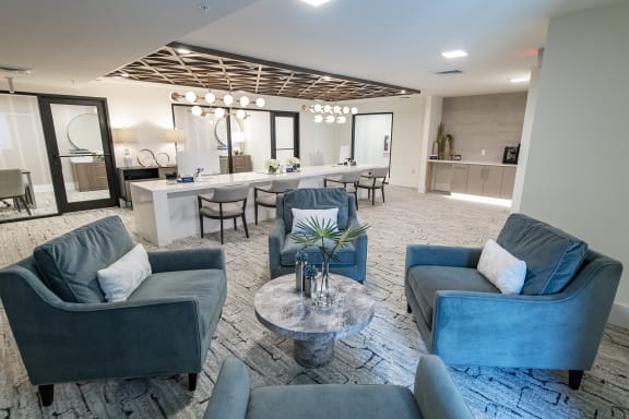 a living room with blue couches and chairs