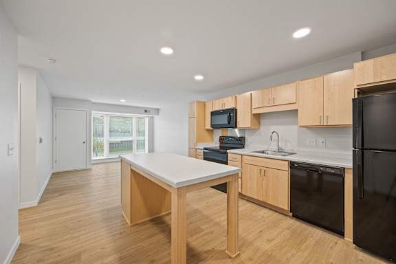 an empty kitchen with wooden cabinets and a white counter top