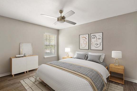 A bedroom with a bed, nightstands, and a ceiling fan.