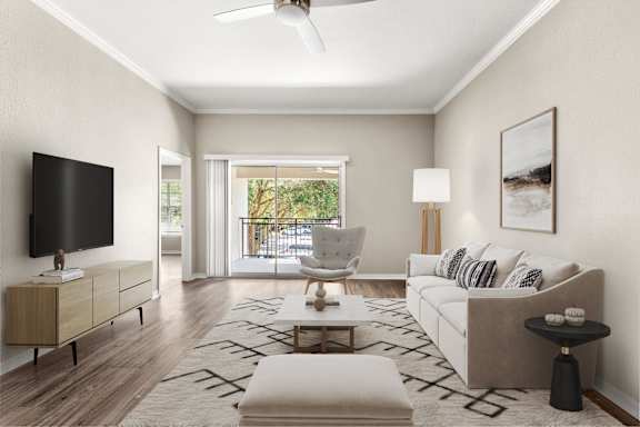 A modern living room with a flat screen TV, a white sofa, and a coffee table.