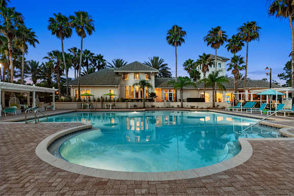 A large house with a pool in front of it.