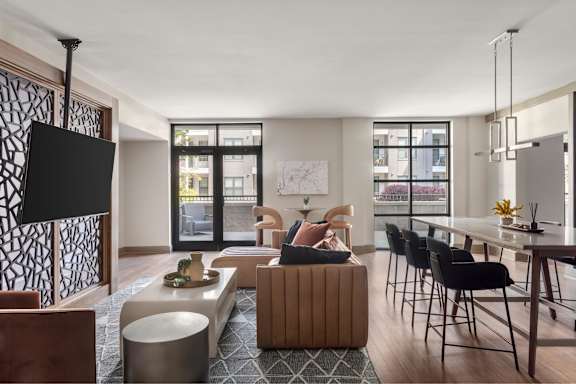 A modern living room with a large window and a flat screen TV.