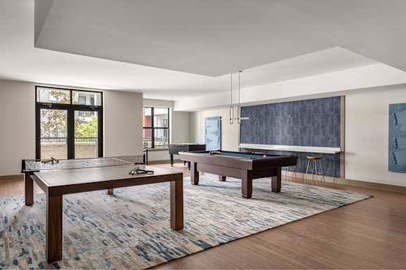 A room with a pool table and a ping pong table.