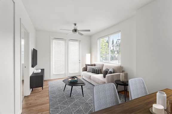 A living room with a couch, a coffee table, and a television.