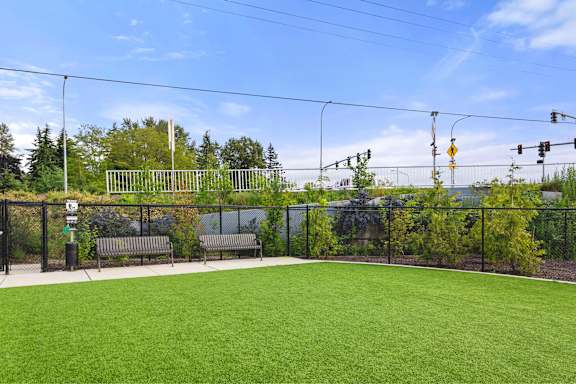 A soccer field with a goal post and a bench.