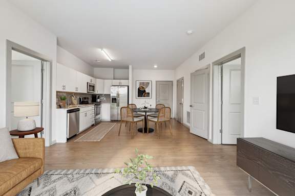 A modern kitchen with a dining table and chairs.