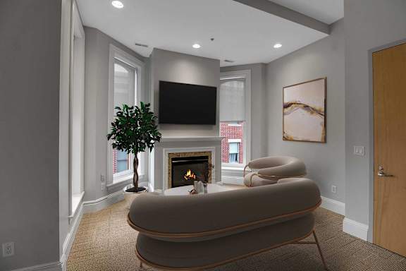 A living room with a fireplace and a television.