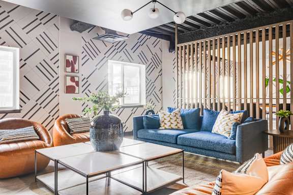 a living room with blue couches and a table