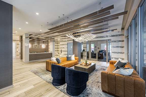 a large lobby with couches and chairs and a reception desk