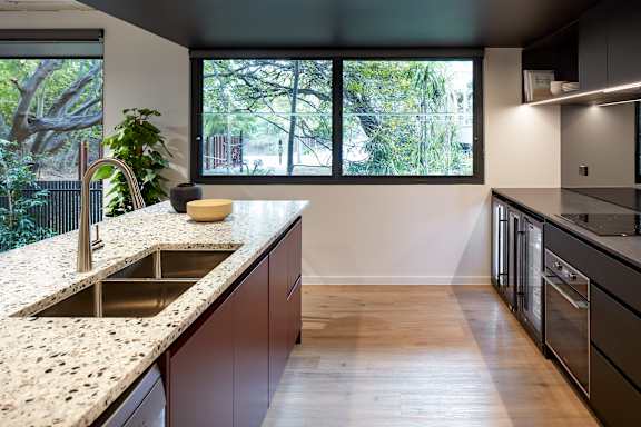 a kitchen with a sink and a large window