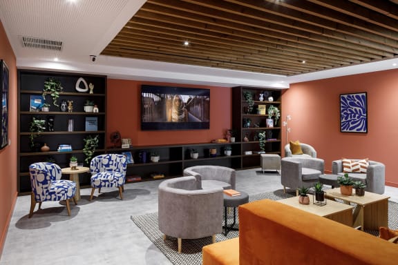 a living room with couches and chairs and a television