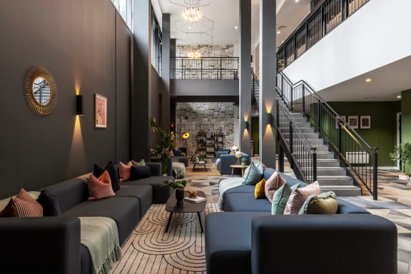the lobby of a building with couches and tables