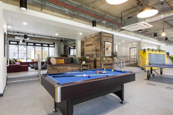 a games room with a foosball table and ping pong table