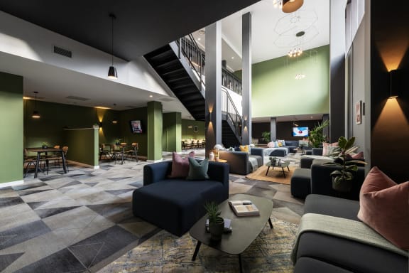 a large lobby with couches and chairs and tables