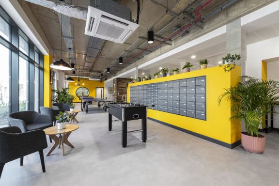 a game room with a yellow wall and a foosball table