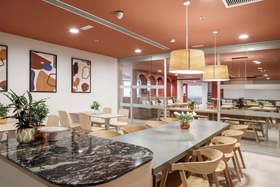 a dining room with tables and chairs and a counter top