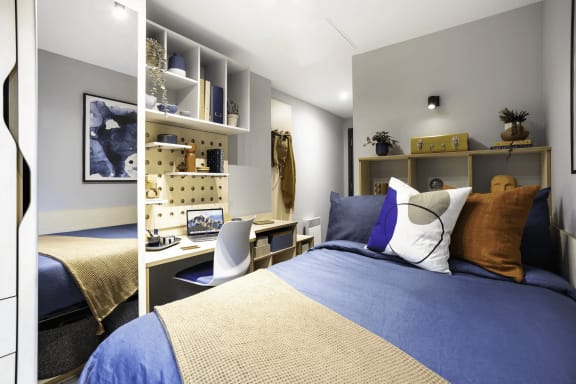 a bedroom with a bed and a desk in it