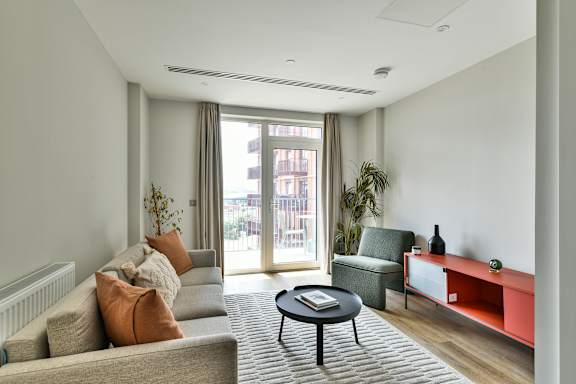 Living room with couch and comfortable chair at The Lark, London
