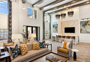 A living room with a couch, chairs, and a fireplace.