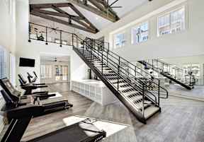 A gym with treadmills and a staircase.
