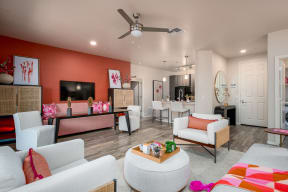 a living room filled with furniture and a ceiling fan