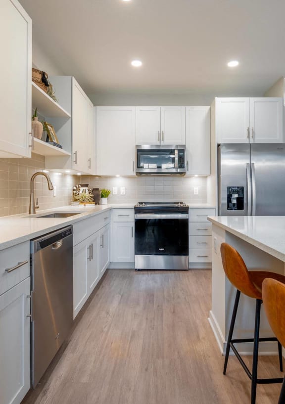 a kitchen with white cabinets and a white counter top