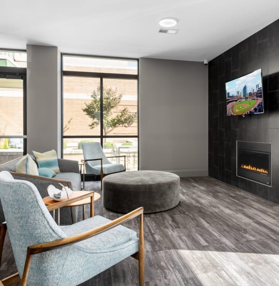 a living room with a fireplace and a tv at Hibernia Apartments, St Louis, Missouri