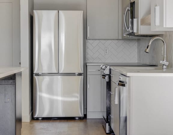 a kitchen with a refrigerator and a sink