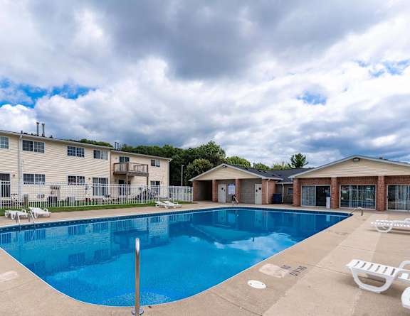 our resort style swimming pool is next to our building with lounge chairs