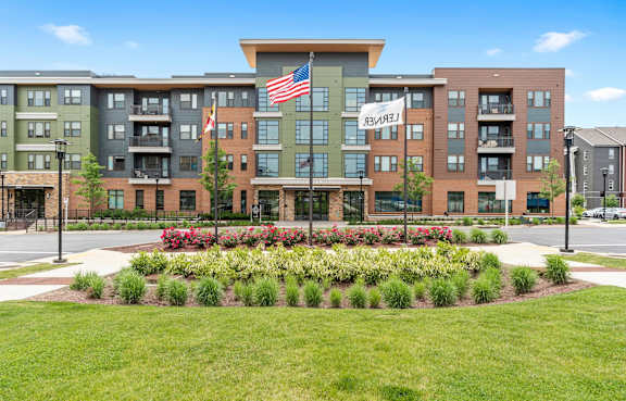 A building with a lawn in front and a sign that says "Bella Vista".
