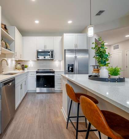 a kitchen with white cabinets and a white counter top
